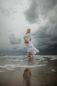 Braut im Bohokleid bei Ihrer Inselhochzeit im Watt von Norderney bei Unwetter.
