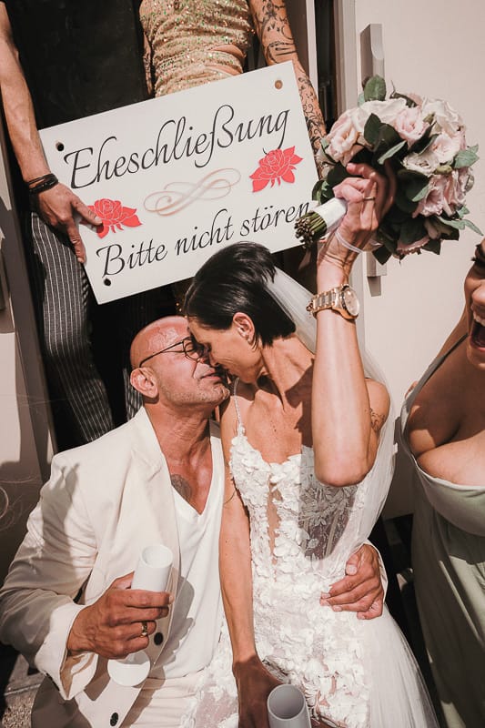 Gruppenfoto vor dem Badekarren am Westbad mit Fokus auf das Hochzeitspaar.